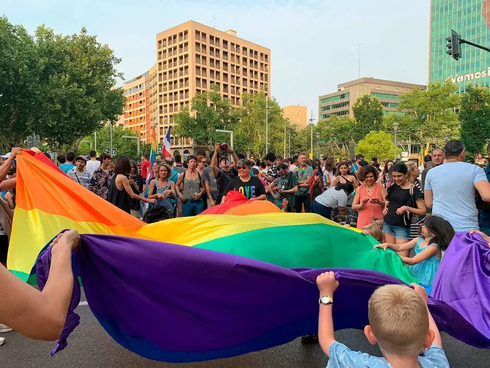 Un grupo de personas mantea la bandera arco&iacute;ris
