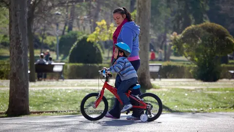 mujer con un ni&ntilde;o montando en bici