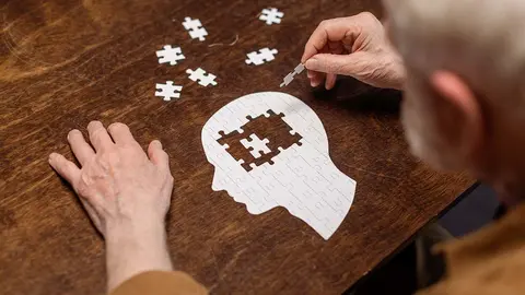 Un hombre mayor realiza un puzzle