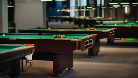 Billiard table with green surface and balls in the billiard club.Pool Game.