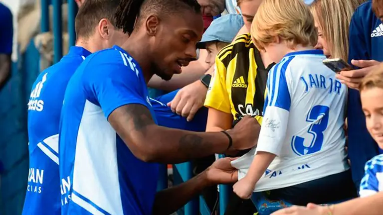 Jair firma una camiseta